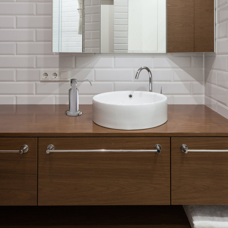 Bathroom sink with vanity top soap dispenser 